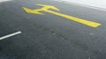 A traffic sign on the road, yellow arrows on the asphalt in the car park Royalty Free Stock Photo