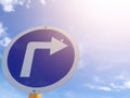 Traffic sign show the turn right on blue sky and sunshine on the top. Royalty Free Stock Photo