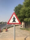 Traffic sign on a street in Doha, Qatar, showing a person in traditional Arabic dress Royalty Free Stock Photo