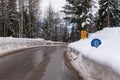 Red triangle road traffic warning sign - Other Danger with text Ausfahrten which means Exits. Snow covered road, trees and mountai Royalty Free Stock Photo