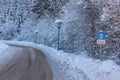 Snow chain obligation, Chain traffic sign. Winter time and winter services. Snow covered road, trees. Austria Royalty Free Stock Photo