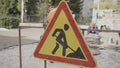 Traffic sign warns drivers to be cautious of workers on road