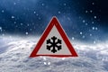 Road sign snow warns of snow and ice in winter, warning sign Royalty Free Stock Photo