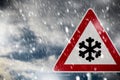 Road sign snow warns of snow and ice in winter, warning sign Royalty Free Stock Photo