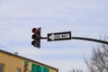 A traffic signal with a red light and a black and white one way sign with blue sky and clouds in the Marietta Square Royalty Free Stock Photo