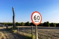 Traffic signpost, which indicates the maximum speed allowed at the location, on a road