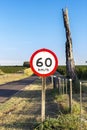 Traffic signpost, which indicates the maximum speed allowed at the location, on a road