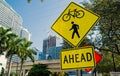 Traffic signs on city road in miami, usa. Bicycle and pedestrian crossing ahead warning. Transportation traffic and Royalty Free Stock Photo