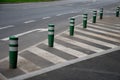 Traffic signs drawn on the road. zebra where he must not stop and park. striping on asphalt with the support of green plastic boll