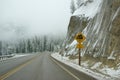 Traffic signs on icy mountain road Royalty Free Stock Photo