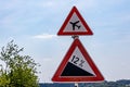 Traffic signs indicating: airport warning sign or low flying airplane and steep 12 percent downhill gradient in road Royalty Free Stock Photo