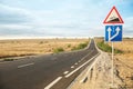 Traffic signs near empty asphalt highway. Road trip Royalty Free Stock Photo