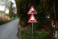 Traffic signs STEEP HILL UPWARDS and UNEVEN ROAD outdoors