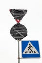 Traffic signs wrapped in black plastic