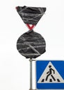 Traffic signs wrapped in black plastic