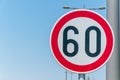 Traffic speed limit sign for restriction on 60 kilometers or miles per hour with blue sky background Royalty Free Stock Photo