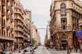 Traffic in a street of Barcelona with beautiful buildings along the roadside.