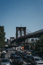 Traffic on a street in Brooklyn, New York, Brooklyn Bridge on the background.