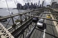 Traffic in sun on Brooklyn Bridge with skyline, Manhattan, New York City