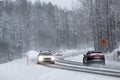 Traffic in snowy winter conditions through the forest