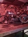 Harley Davidson flathead racer, sat on a shelf in a bar.