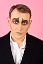 Tragical actor. Man with mime makeup. Mime artist. Mime with face paint. Theatre actor miming. Stage actor miming