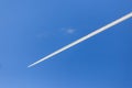 Trail from an airplane in a blue sky Royalty Free Stock Photo