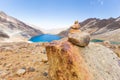 Trail cairn duck rocks pile sign mountains lake, travel Bolivia.