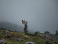 Trail direction sign on a rocky field on the Himachal Pradesh Mountain Range in India Royalty Free Stock Photo