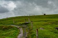 Trail with a dolmen in the background in the coastal route walk from Doolin to the Cliffs of Moher Royalty Free Stock Photo