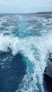 trail of foam and turquoise blue water left in the water by a speeding outboard motor, wake of turquoise blue water Royalty Free Stock Photo