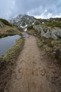 A trail with the German words Auf geht`s written into the mud near the Aletsch glacier in the Swiss alps