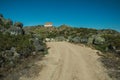 Trail in the highlands with a lonely house on top Royalty Free Stock Photo