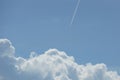 Trail from a jet plane white clouds blue sky Royalty Free Stock Photo