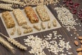 Trail mix, Cereal granola bars, sunflower seeds, raisins and wheat sprig on wooden background Royalty Free Stock Photo