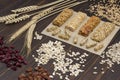 Trail mix, Cereal granola bars, sunflower seeds, raisins and wheat sprig on wooden background Royalty Free Stock Photo