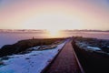 Trail in mountains covered with snow in Badlands National Park, South Dakota at sunset Royalty Free Stock Photo