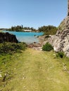 Trail park grass green hidden rocks grey ocean low tide high tide