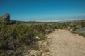 Trail passing through rocky terrain on highlands Royalty Free Stock Photo