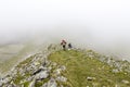 Trail runners in a mountain race and tourists hiking on Retezat mountain