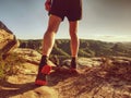 Trail runner in natural terrain, body contour in low ankle view