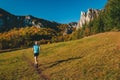 Trail runner train in beautiful autumn landscape. Carpathian forest and rocky hills in background