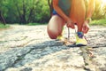 Trail runner tying shoelaces on rocky trail in forets Royalty Free Stock Photo