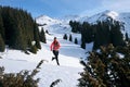 Trail runner woman running in winter mountains on snow. Royalty Free Stock Photo