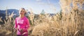 Trail running athlete exercising for fitness. Young woman smiling runner run in nature in mountains.