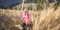 Trail running athlete exercising for fitness. Young woman smiling runner run in nature in mountains.