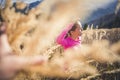 Trail running athlete exercising for fitness. Young woman smiling runner run in nature in mountains.