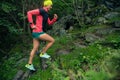 Trail running girl in green forest. Royalty Free Stock Photo