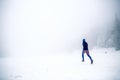 Trail running woman on snow in winter mountains Royalty Free Stock Photo