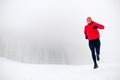 Trail running woman on snow in winter mountains Royalty Free Stock Photo